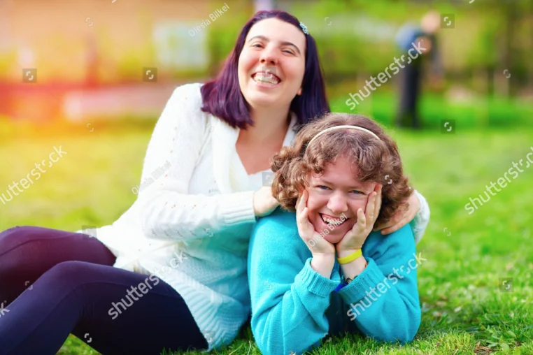 Two Young People Sitting Together