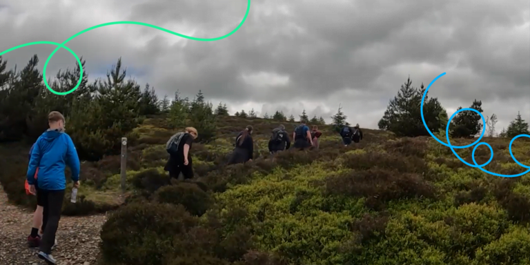 Students on Duke of Edinburgh walking up a hill with their backs to camera